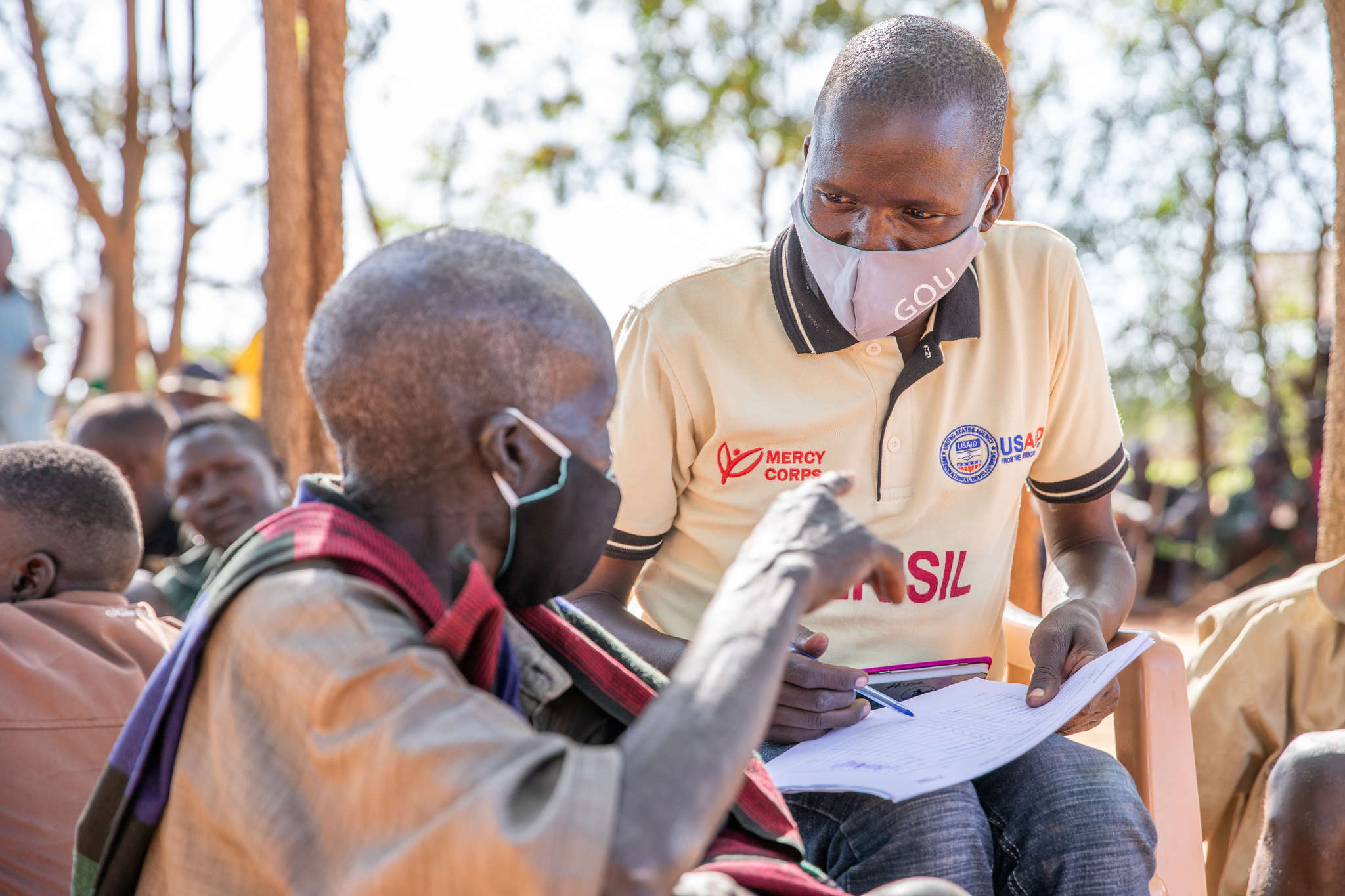 Mercy Corps team member, James Longok, speaks with people in Karamoja during a peace-building session.