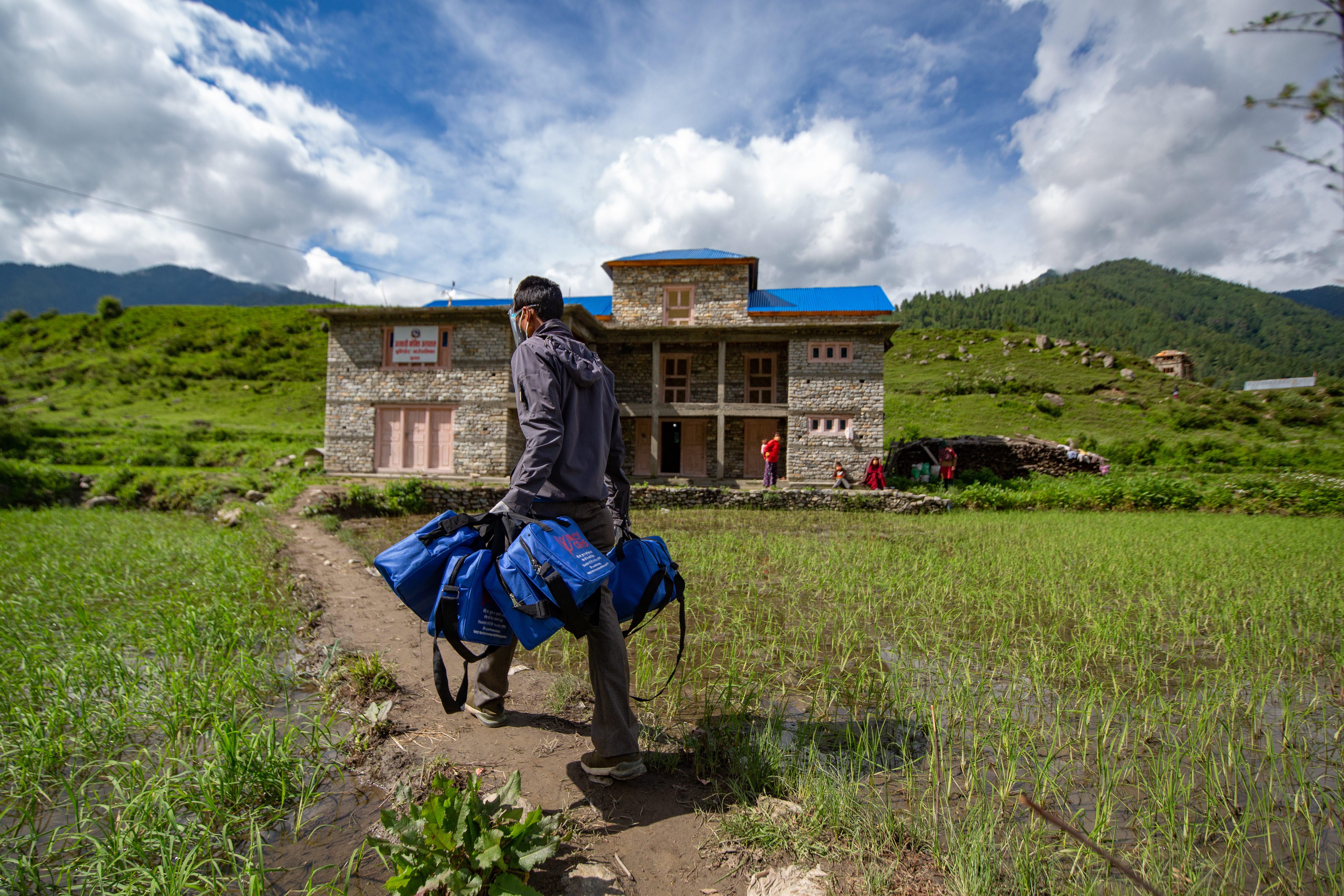 A health worker delivering covid-19 kits to an isolation center in jumla, nepal.