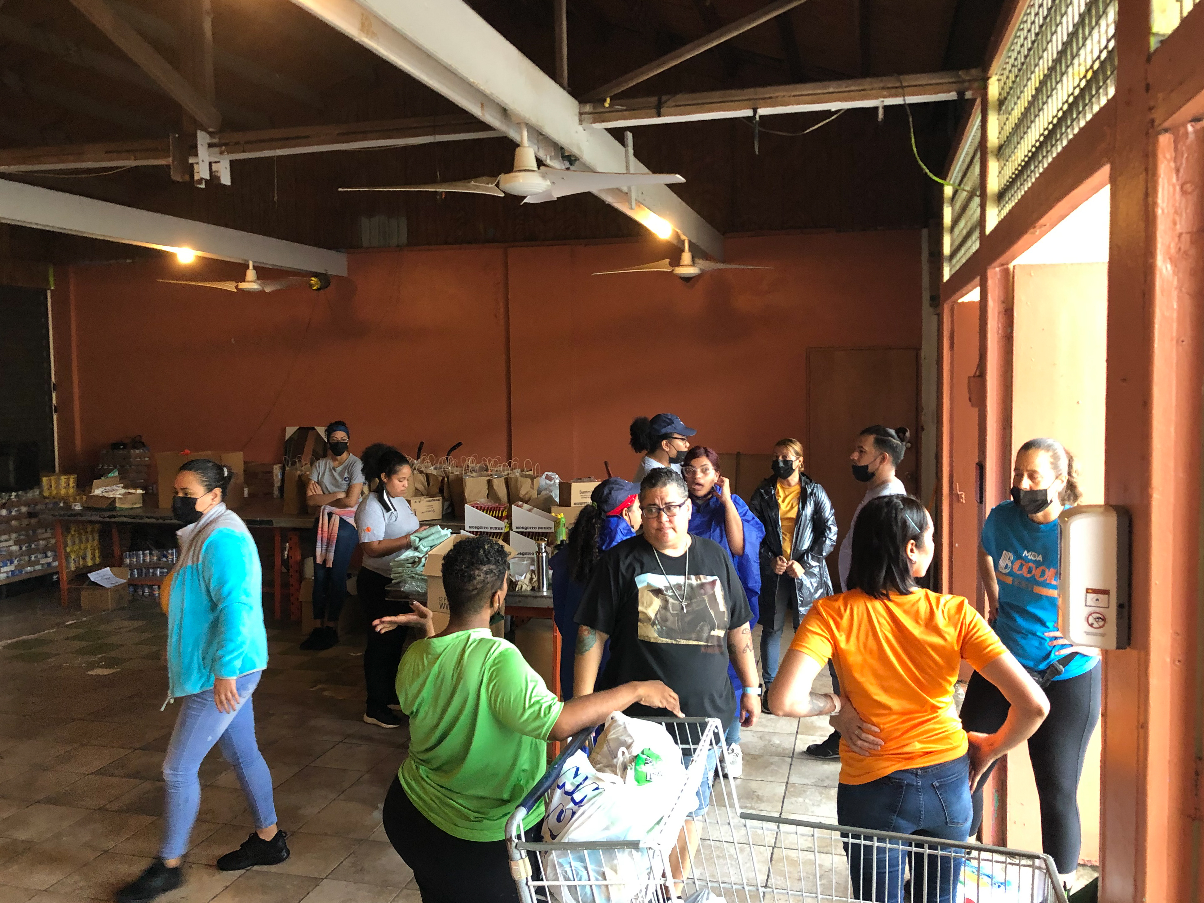 In cataño, puerto rico, volunteers at association pro juventud y comunidad de barrio palmas, a mercy corps resilience hub, prepare supplies for distribution. 