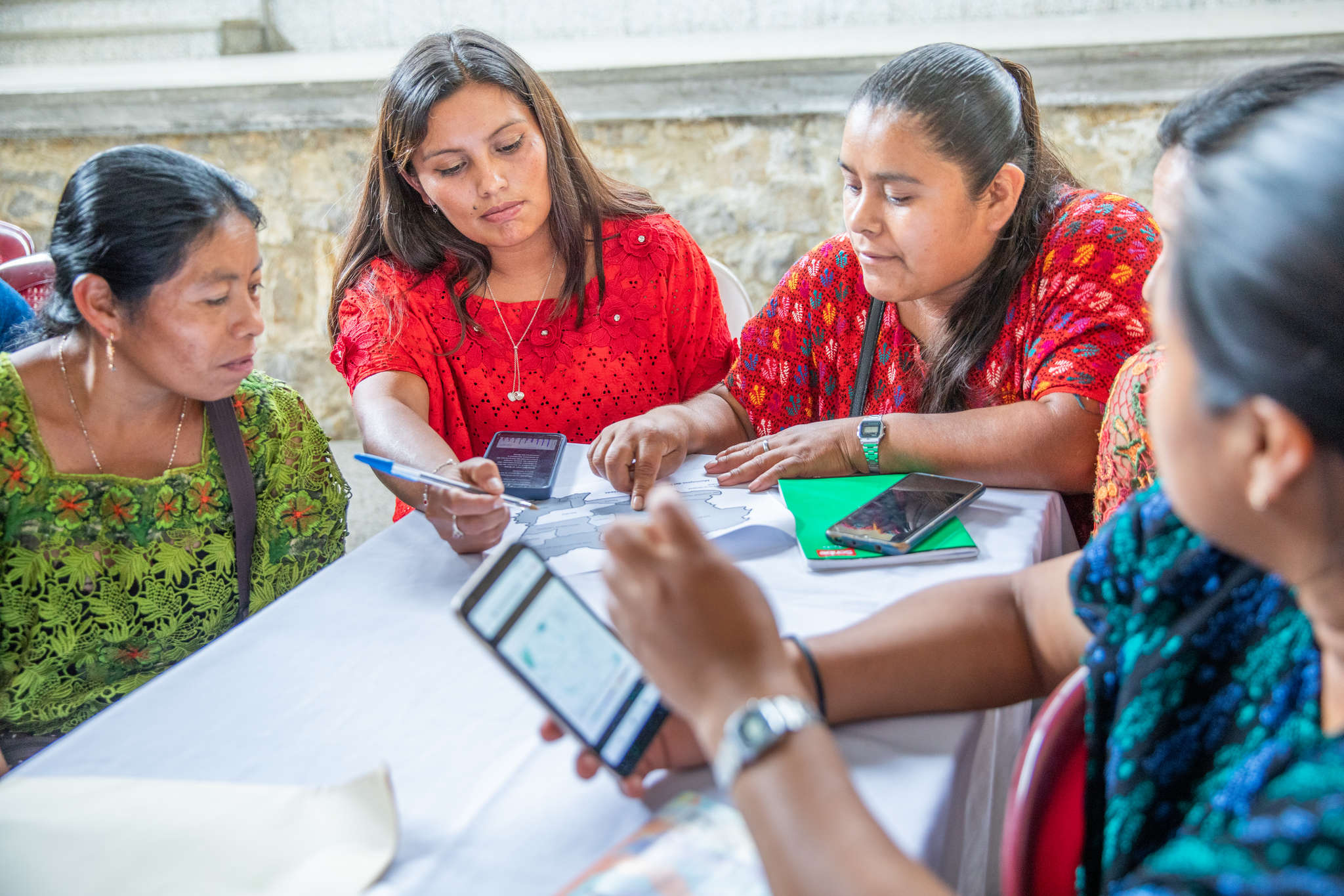 Farmers sitting at a table during a workshop.