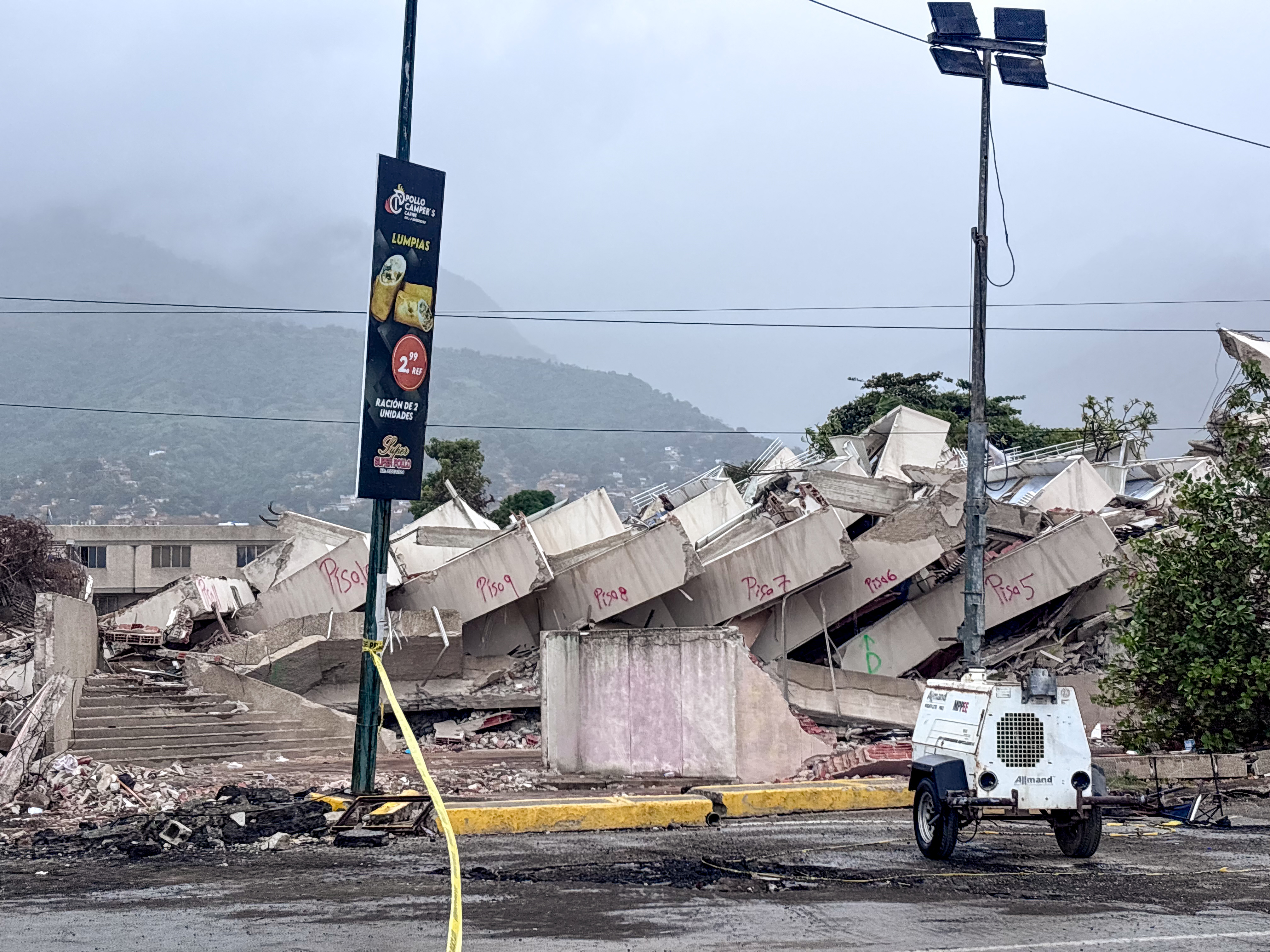 Collapsed building in venezuela with portable lighting in the foreground; this damage is due to major earthquakes that struck the country in june 2026.
