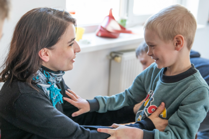 Day care centre owner looking after young boy, Ukraine