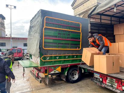 Two men unload a supply truck in Lebanon