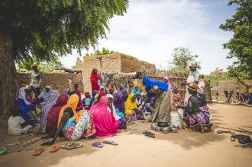 Woman and children gathered outdoors in niger