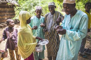 Dahara sells caramelized nuts to people in the community