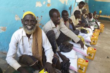 Men sitting with supplies in somalia
