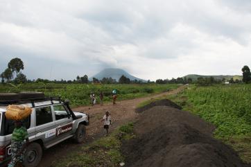 Looking toward mt. nyiragongo volcano, mercy corps/usaid vehicle in foreground. photo: liz hummer/mercy corps