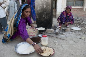 Women cooking flatbread in pakistan