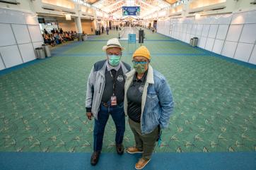 The owners of a small business pose for the camera in portland international airport where their shop is located. 