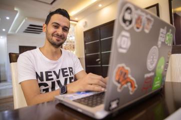 A young person using a laptop computer.