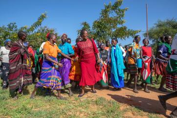 Women from the jie community in karamoja, uganda dance and sing peace songs before a dialogue session with a neighboring community.