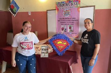 Rosana (left) and karely show off their wares at a fair for sustainable businesses.
