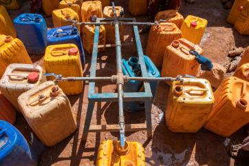 Jerry cans being filled with water