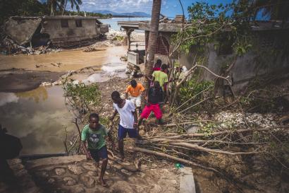 A group walking near a stream in haiti after hurricane matthew