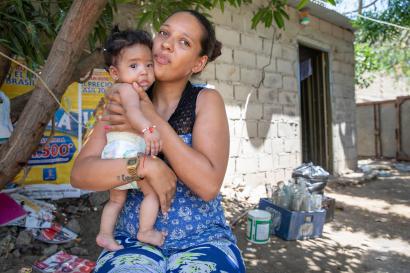 Mother and child outside of their home.