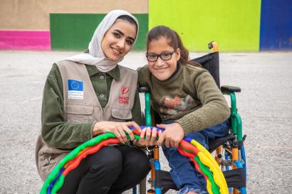 Mercy corps employee and program participant sitting together.