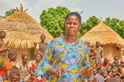 A farmer speaks to a large group of people.