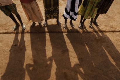 The shadows of six young people standing in a row. 