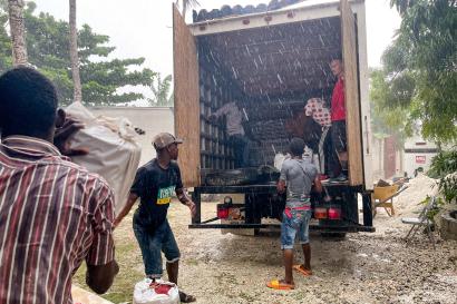 People unload supplies from a truck