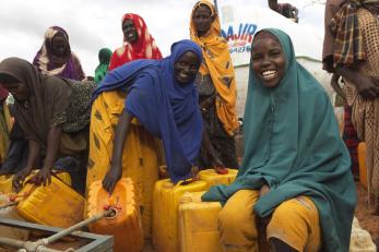 Women at the kerow-margan camp in baidoa, filling containers with clean water.