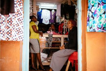 Zipporah with two other women inside the doorway of her store