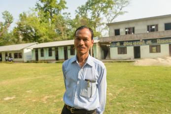 Sarmila's principal standing in front of the school