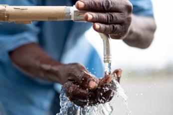 A man uses a tap for water in the bahamas. photo: mission resolve