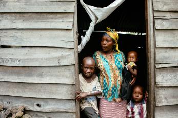 A woman and three children in the doorway of their home in drc
