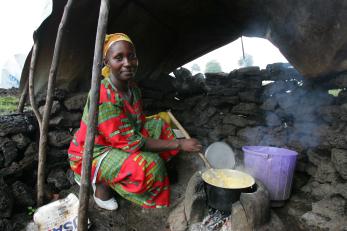 A woman stirs a pot of food in dr congo