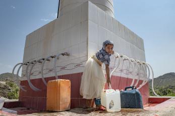 A girl gets water from a solar-powered well