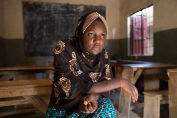 A woman sitting in a classroom in nigeria