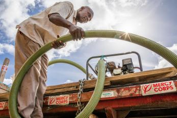 Bahamian working with a water tender truck.