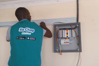 A person works with electrical equipment in kenya.