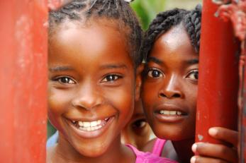 Two young people smile for the camera in haiti