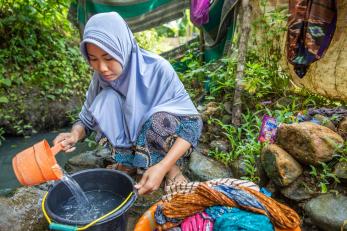 Khodijah washes her laundry in a river in lebak, indonesia