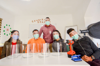 Members of ecohub posing with 3d printed personal protective equipment.