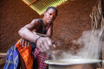Akol maria, 25, cooks traditional porridge for her children.