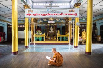 A buddhist monk studying in a monastery.