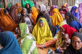 Displaced women and children gather in a shed to escape the midday heat at a camp for internally displaced people outside of mogadishu.