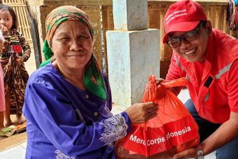 Mercy corps staff and community member interact.