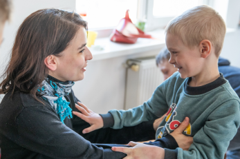 Day care centre owner looking after young boy, ukraine