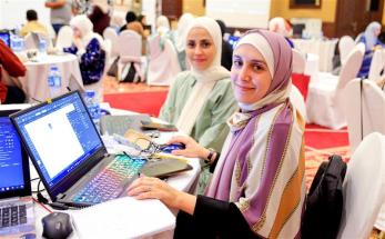 Two women working on a laptop together
