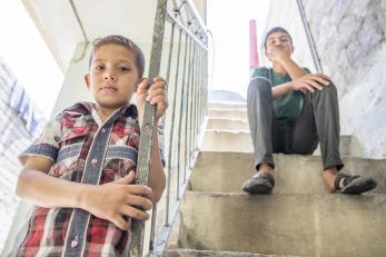 Two iraqi boys on a staircase.