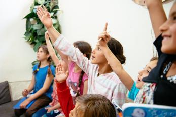 Children raising their hands