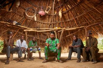 Nigerian pastoral community members meet in a hut.