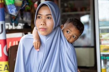 Khodijah and her son in front of her shop in indonesia