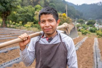 A farmer standing in their field.