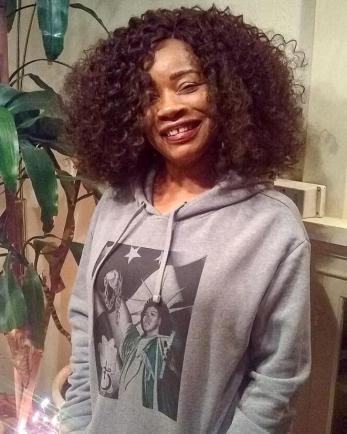 Smiling woman with hoodie on.