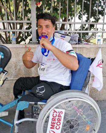 An excited person in a customized wheelchair after winning a race.