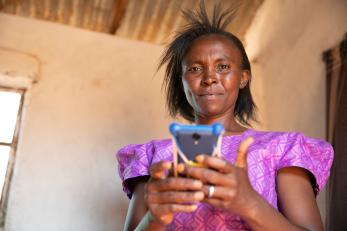 Lydia with cell phone in Kenya